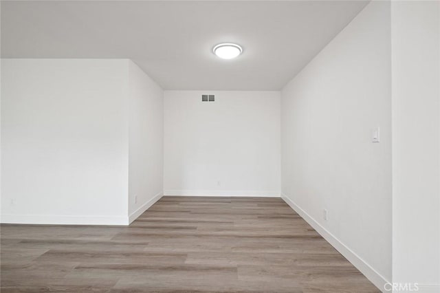 unfurnished room with light hardwood / wood-style floors