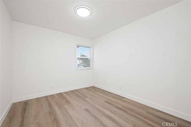 spare room with light wood-type flooring