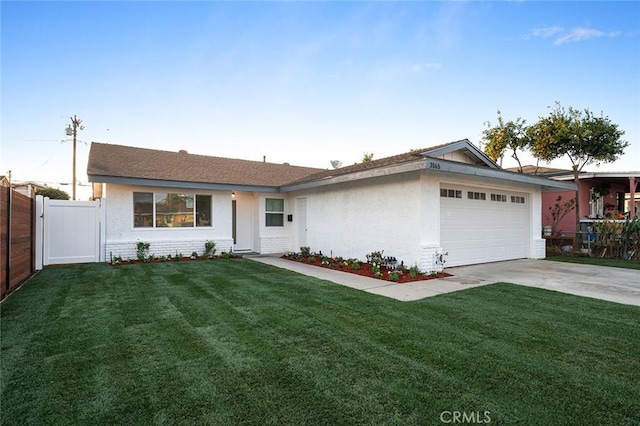 ranch-style home featuring a garage and a front lawn