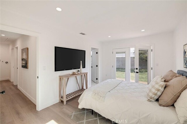 bedroom featuring access to exterior and light wood-type flooring