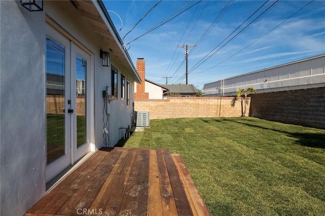 view of yard with cooling unit and french doors