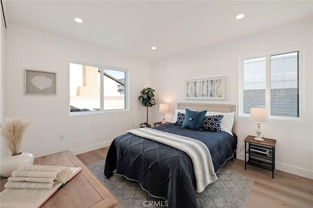 bedroom with light wood-style flooring, baseboards, and recessed lighting