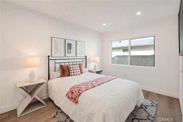 bedroom featuring recessed lighting, wood finished floors, and baseboards