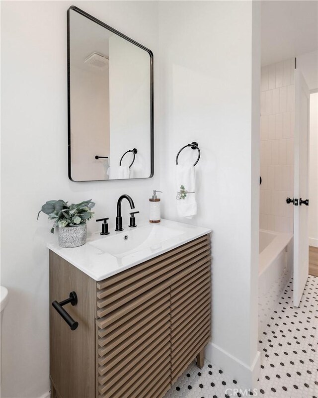 bathroom with vanity, tile patterned floors, and bathing tub / shower combination