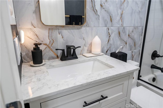 bathroom with vanity and shower / bath combination with glass door