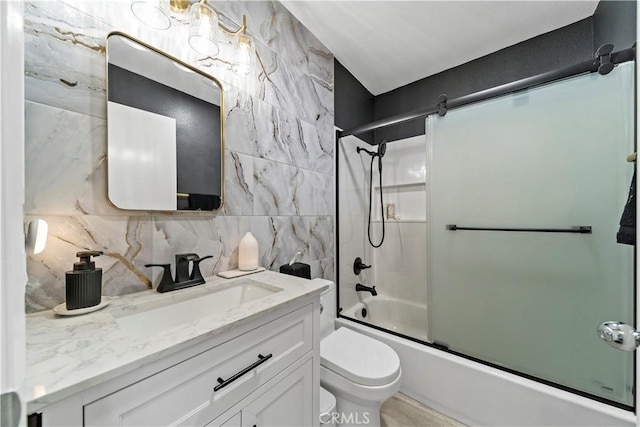 full bathroom with vanity, backsplash, toilet, and combined bath / shower with glass door