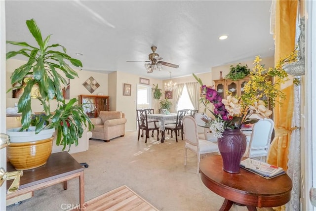 carpeted living room with ceiling fan