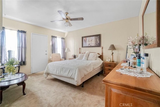 bedroom with ceiling fan and light carpet