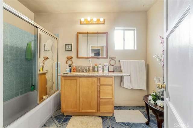 bathroom with tile patterned flooring, enclosed tub / shower combo, and vanity