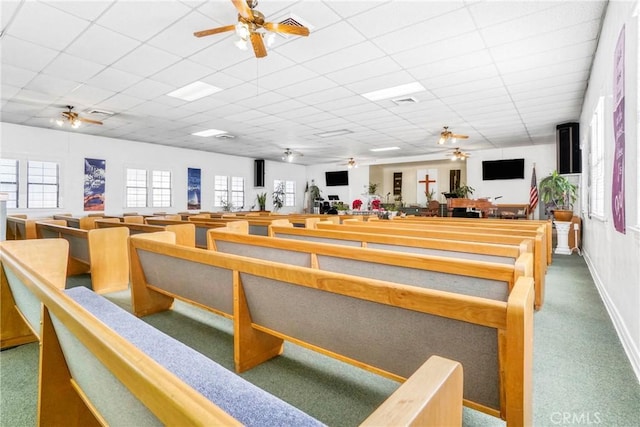 misc room with a paneled ceiling and ceiling fan