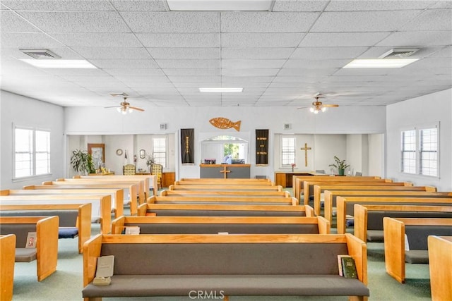 misc room featuring ceiling fan, a paneled ceiling, and carpet