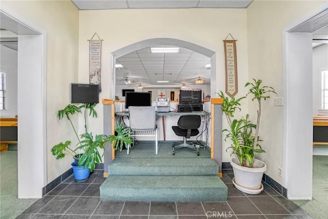 home office featuring a paneled ceiling and a healthy amount of sunlight