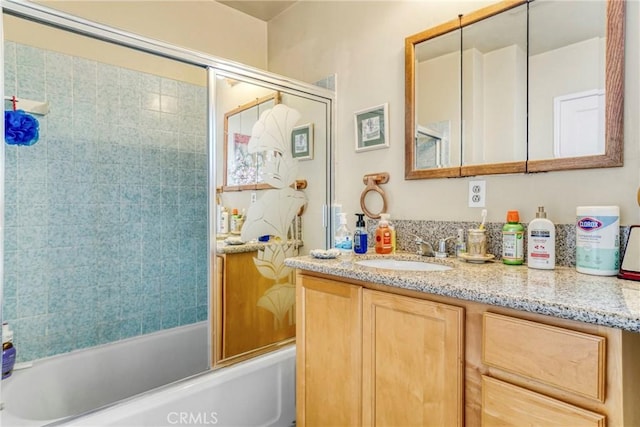 bathroom with vanity and combined bath / shower with glass door