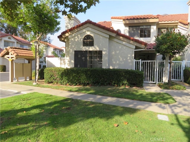 mediterranean / spanish-style home featuring a front yard