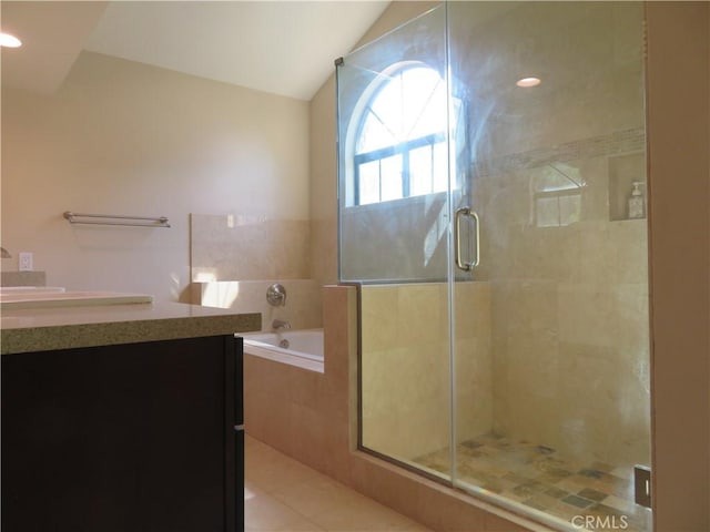 bathroom with vanity, vaulted ceiling, tile patterned floors, and plus walk in shower