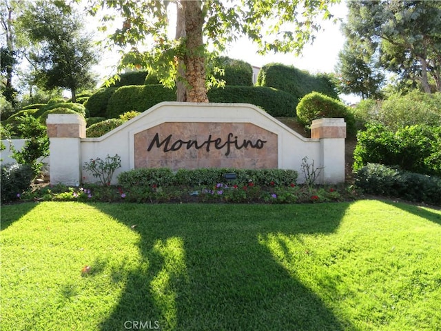 community / neighborhood sign with a lawn