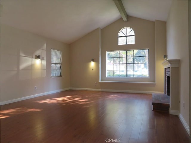 unfurnished living room with dark wood-type flooring, a fireplace, and lofted ceiling with beams