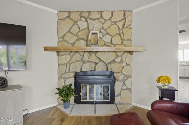 interior details featuring crown molding, wood-type flooring, and a fireplace