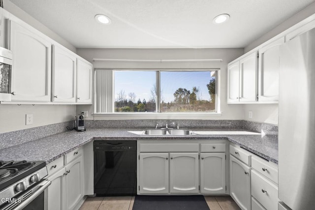 kitchen with a healthy amount of sunlight, white cabinets, sink, and dishwasher