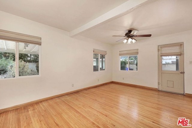 empty room featuring beam ceiling, ceiling fan, and light wood-type flooring