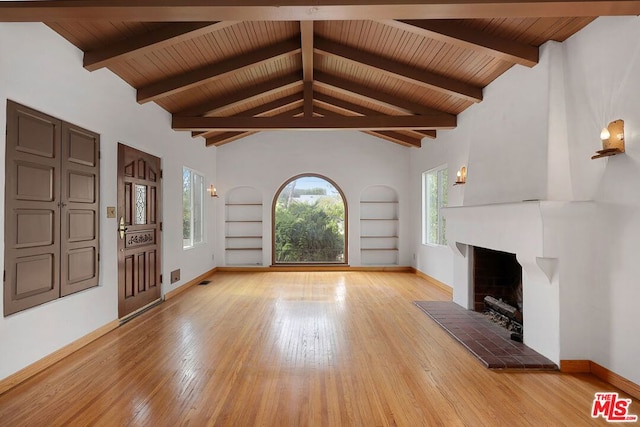 unfurnished living room with a brick fireplace, built in features, light wood-type flooring, and wood ceiling