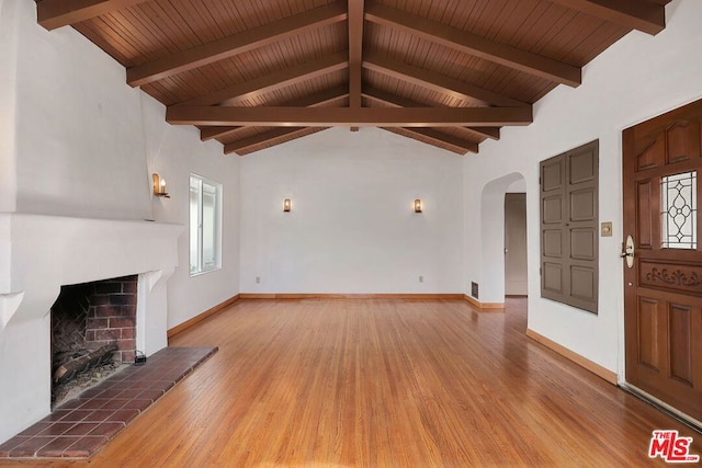 unfurnished living room featuring a brick fireplace, vaulted ceiling with beams, hardwood / wood-style floors, and wood ceiling