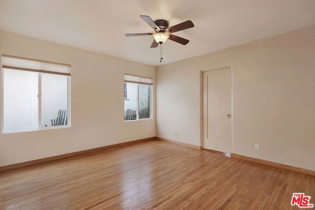 empty room with light hardwood / wood-style flooring and ceiling fan