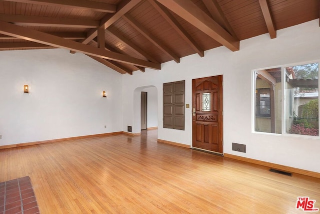 interior space with vaulted ceiling with beams, hardwood / wood-style flooring, and wooden ceiling