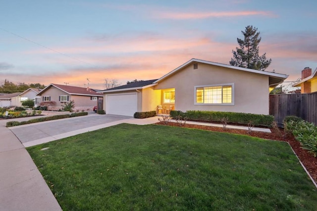 ranch-style home with a yard and a garage