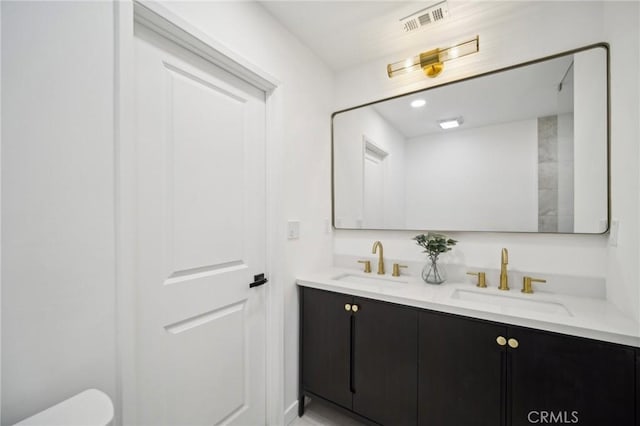 bathroom featuring vanity and toilet