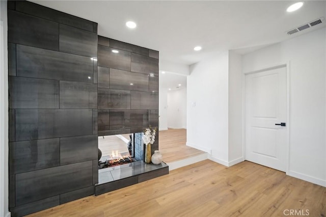 living room with a fireplace and light hardwood / wood-style flooring