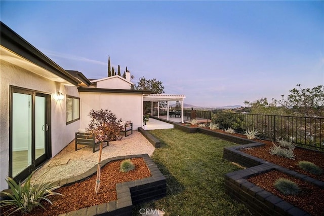 yard at dusk with a pergola and a patio