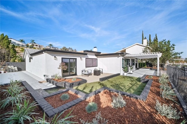 rear view of property featuring a pergola and a patio