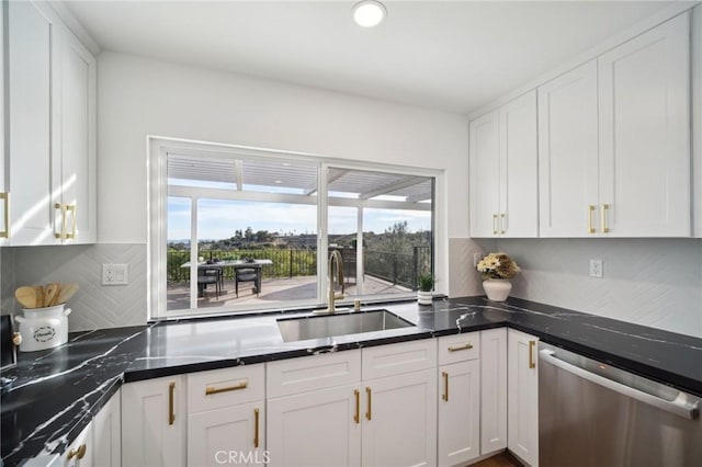 kitchen featuring sink, white cabinetry, backsplash, a healthy amount of sunlight, and stainless steel dishwasher