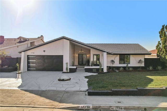 view of front of property with a garage and a front yard