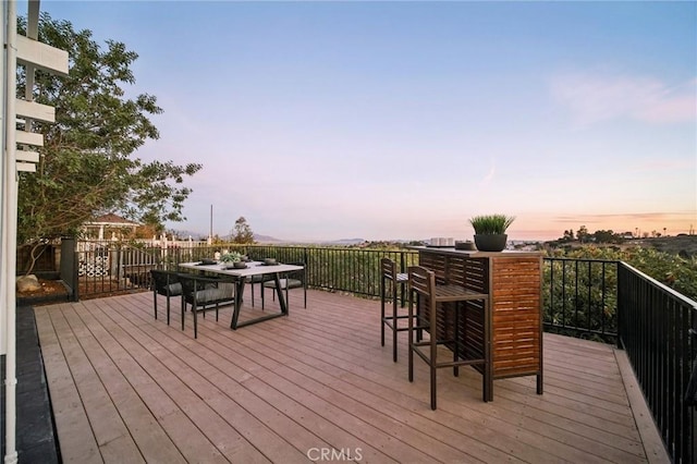 deck at dusk with a bar