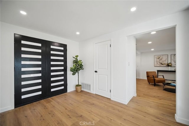 foyer featuring light hardwood / wood-style flooring and french doors