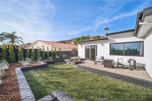 back of house with a lawn and a patio area