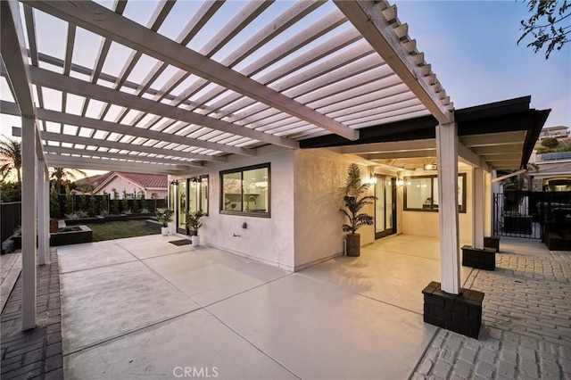 patio terrace at dusk featuring a pergola