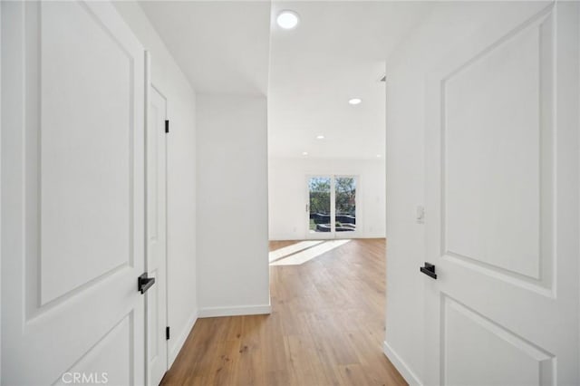 corridor with light hardwood / wood-style flooring