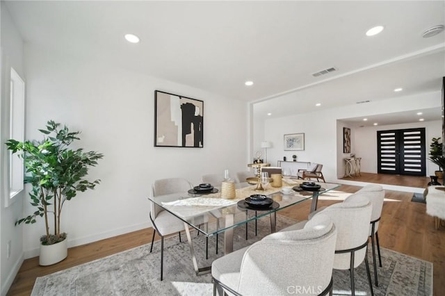 dining space with hardwood / wood-style flooring