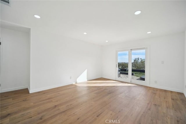 spare room featuring hardwood / wood-style flooring