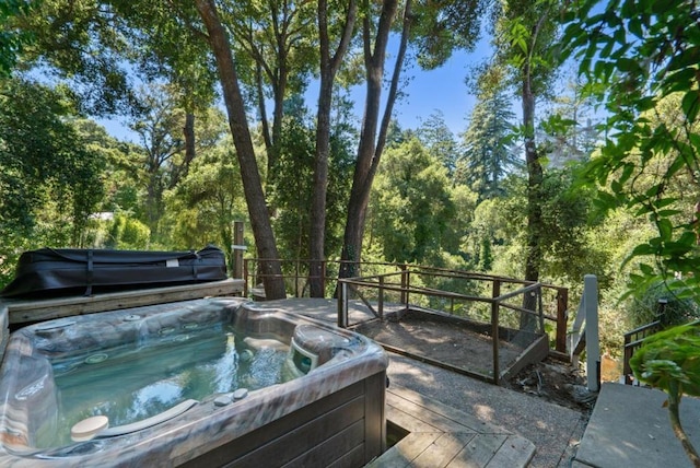 view of swimming pool featuring a hot tub and a deck