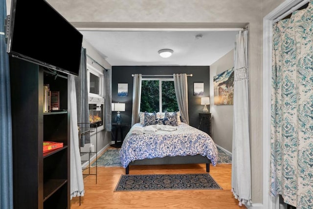 bedroom with hardwood / wood-style flooring