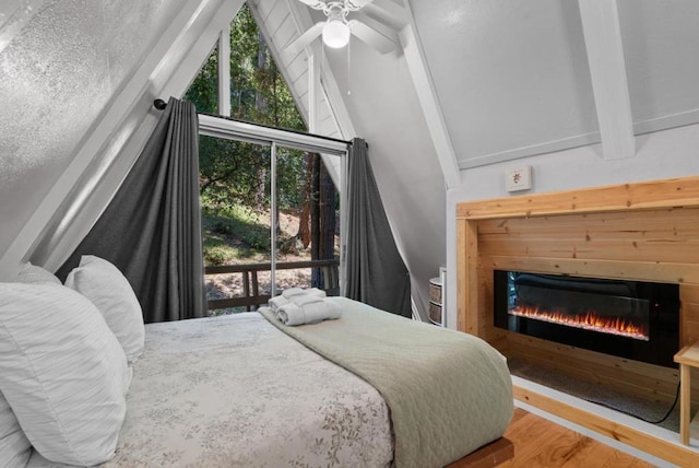 bedroom featuring multiple windows, access to outside, ceiling fan, and light hardwood / wood-style flooring