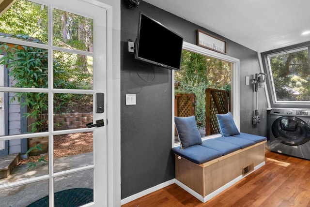 doorway featuring hardwood / wood-style flooring and washer / dryer