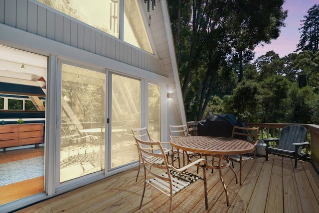 deck at dusk with grilling area