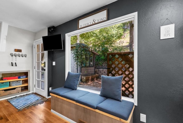 unfurnished room featuring plenty of natural light and hardwood / wood-style floors