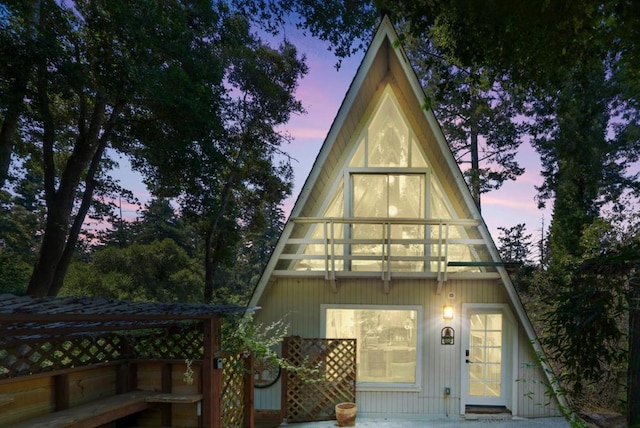 view of back house at dusk