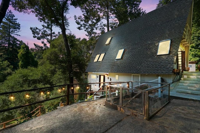 view of back house at dusk